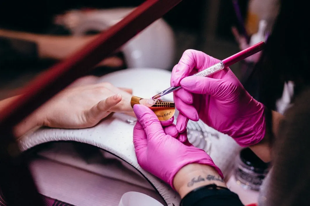 Nail artist painting a manicure